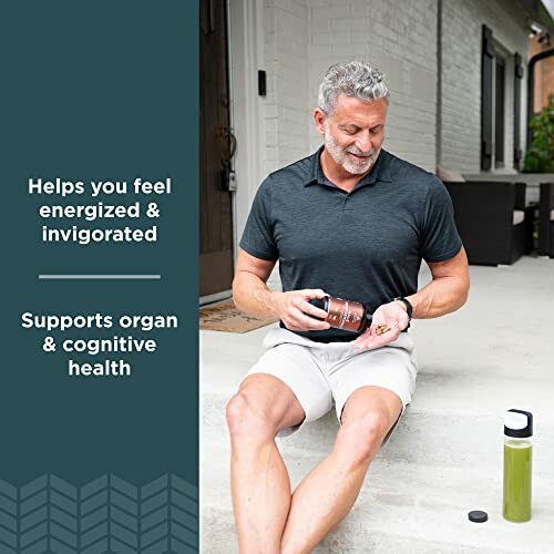 Man sitting on porch taking supplements, with a green drink bottle nearby.